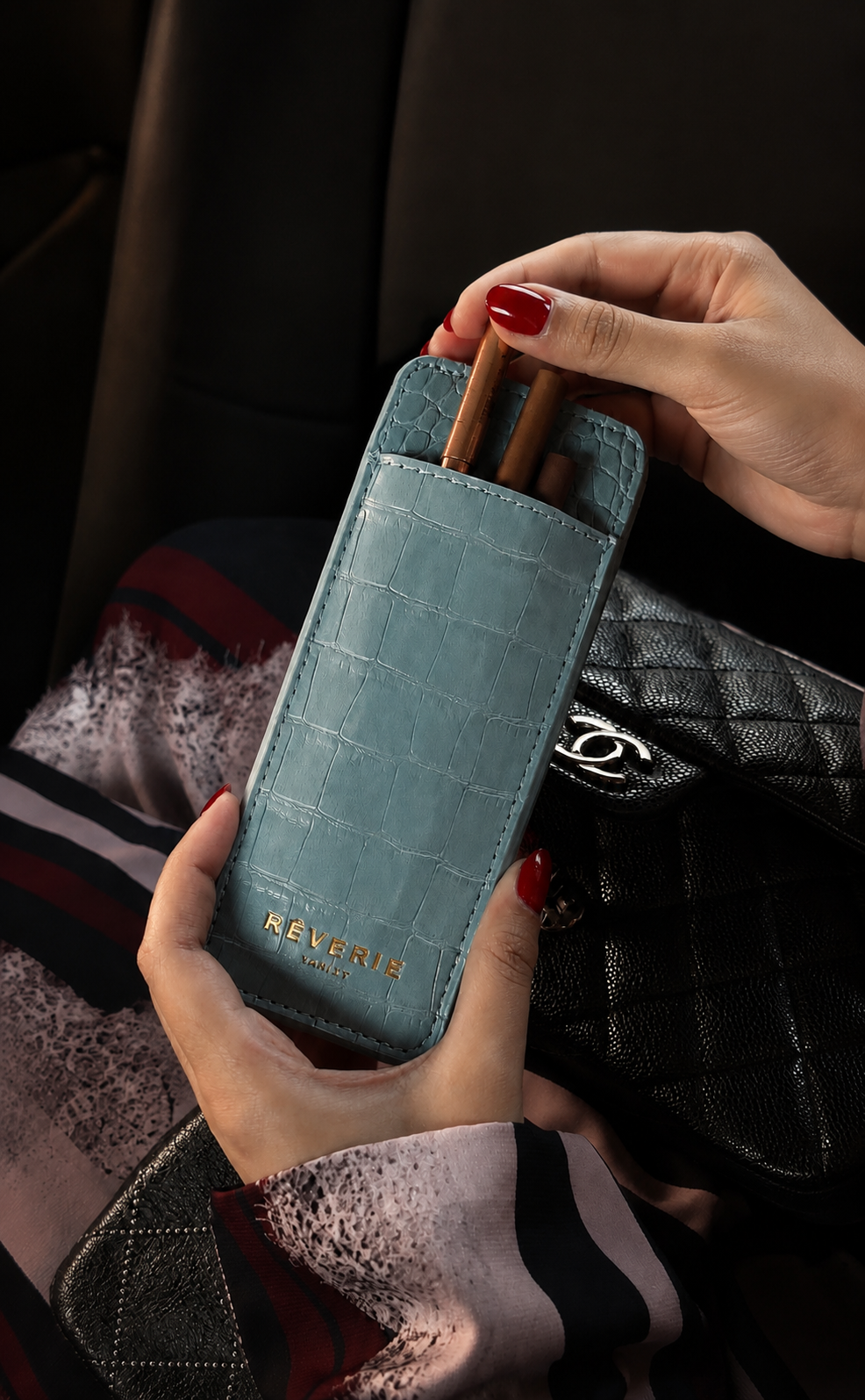 Rêverie Vanity lip liner case in embossed croc, held in hand
